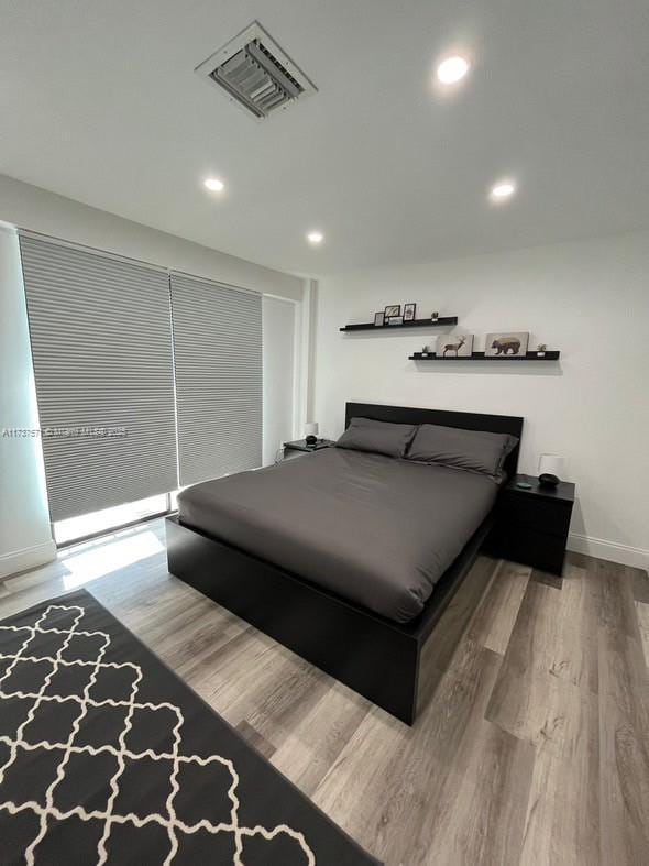 bedroom with wood-type flooring