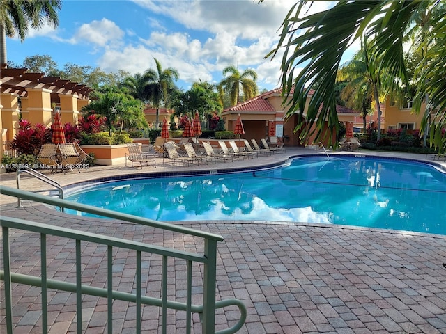 view of swimming pool with a pergola and a patio