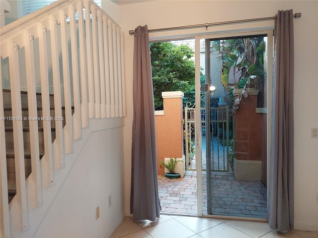 doorway to outside featuring light tile patterned floors