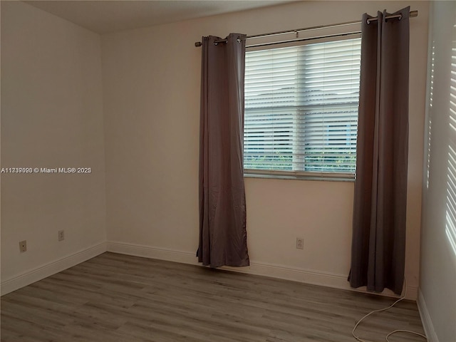 spare room with hardwood / wood-style flooring