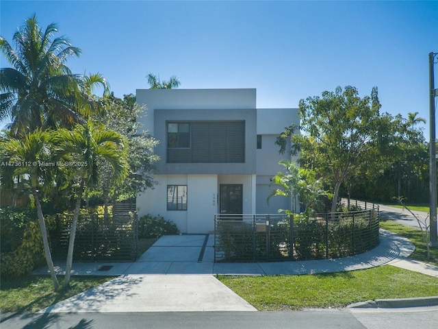 view of front of house featuring stucco siding and fence