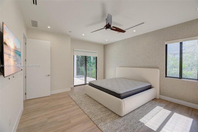 bedroom featuring access to exterior, ceiling fan, and light hardwood / wood-style flooring