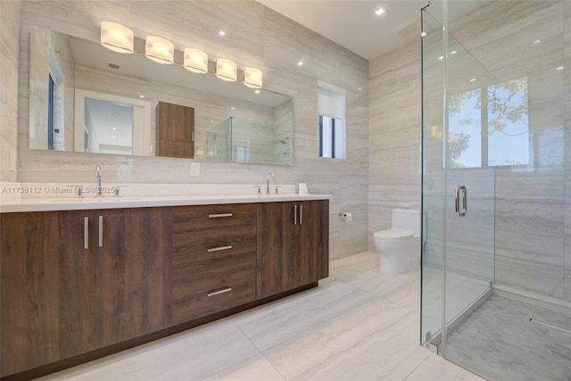 bathroom with walk in shower, tile walls, vanity, and toilet