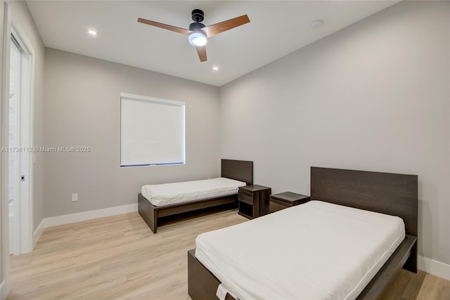 bedroom with light hardwood / wood-style flooring and ceiling fan