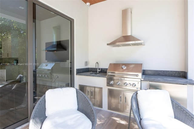 view of patio / terrace with an outdoor kitchen, a sink, and area for grilling
