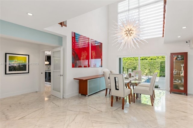 1251 Kane Concourse, Bay Harbor Islands, FL 33154 - dining area featuring a chandelier, a towering ceiling, light marble finish floors, and recessed lighting