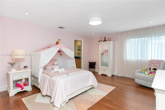 bedroom with hardwood / wood-style flooring