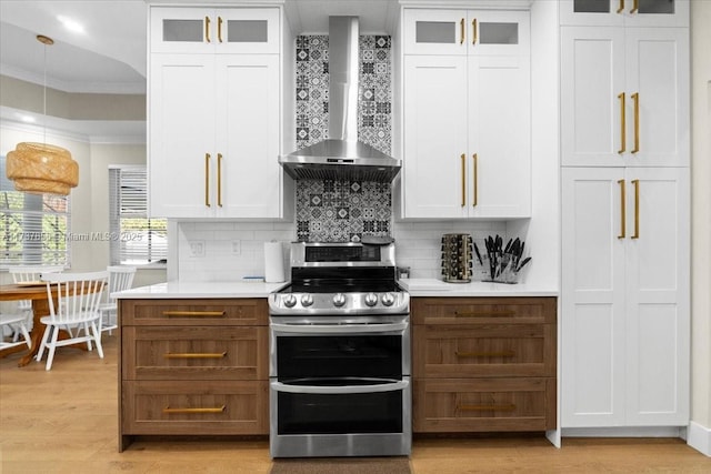 kitchen with white cabinetry, double oven range, and wall chimney exhaust hood