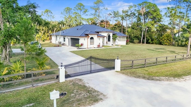 view of front of home featuring a garage and a front lawn