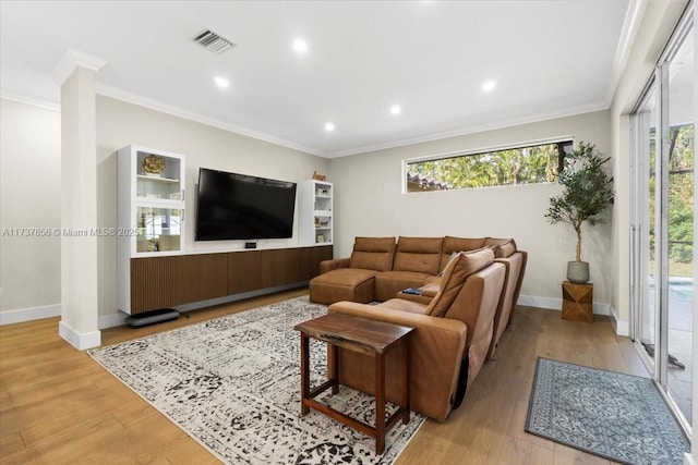 living room with ornamental molding and light wood-type flooring