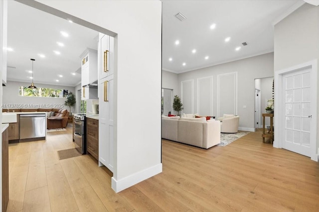 living room featuring ornamental molding and light hardwood / wood-style floors