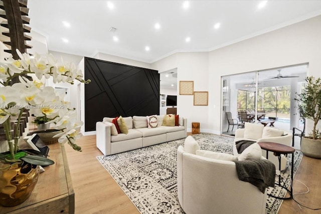 living room featuring light hardwood / wood-style flooring, ornamental molding, and ceiling fan