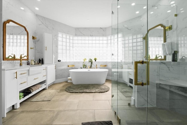 bathroom featuring vanity, tile walls, and separate shower and tub