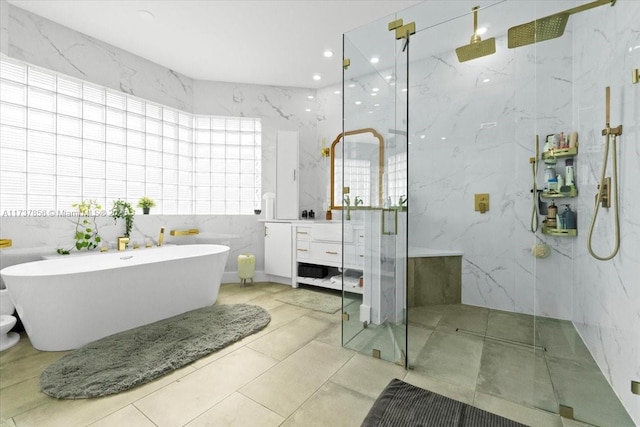 bathroom with vanity, shower with separate bathtub, and tile walls