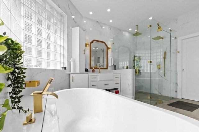 bathroom featuring vanity, plus walk in shower, and tile walls