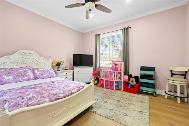 bedroom featuring ornamental molding, ceiling fan, and light hardwood / wood-style flooring