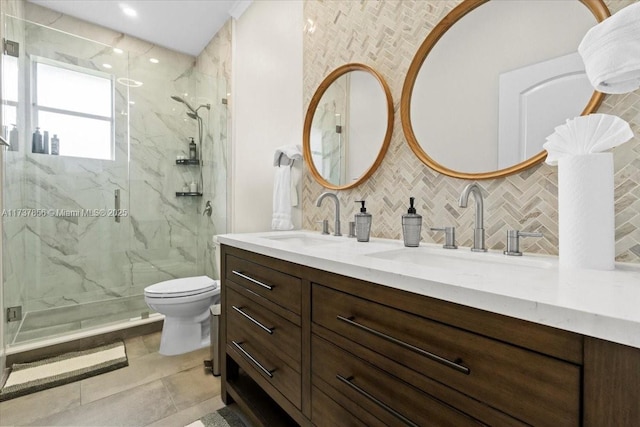 bathroom featuring tasteful backsplash, vanity, a shower with shower door, and toilet