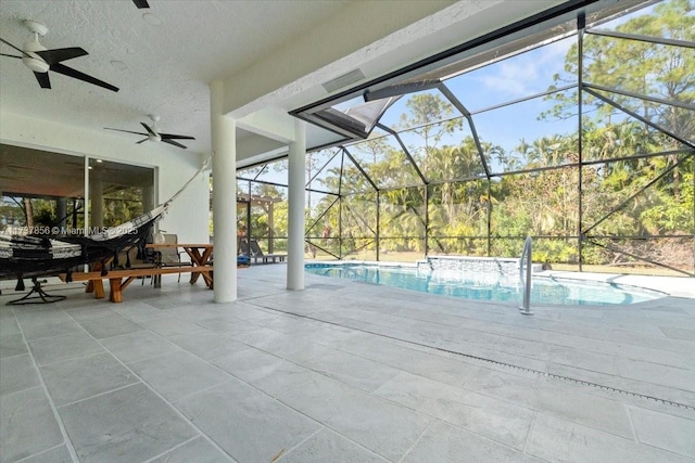 view of pool with a lanai, ceiling fan, and a patio area