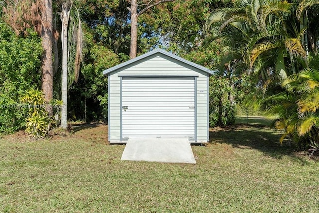 view of outbuilding featuring a lawn