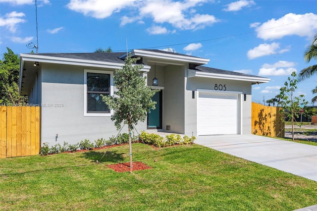 view of front facade with a garage and a front lawn