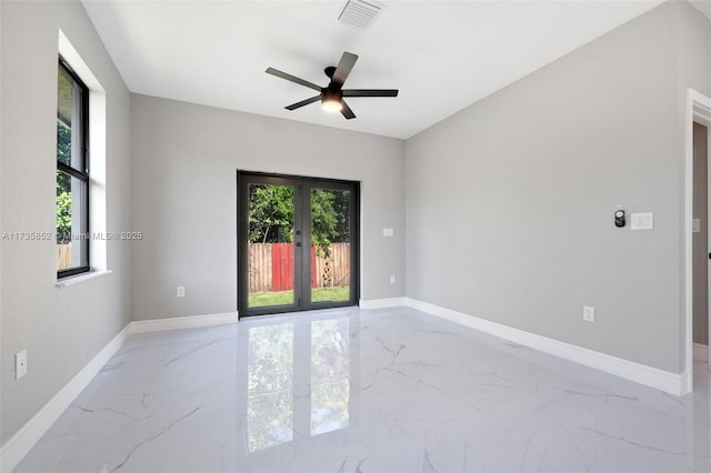 spare room with french doors and ceiling fan