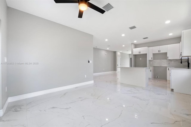 interior space with ceiling fan and sink