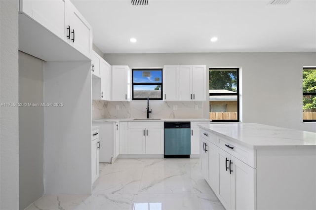 kitchen with dishwasher, sink, and white cabinets