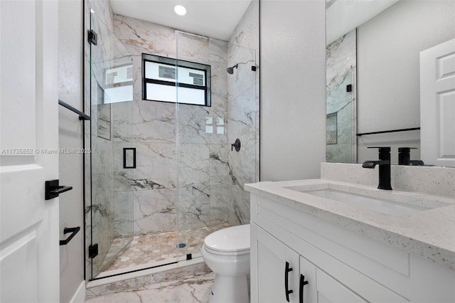 bathroom featuring vanity, walk in shower, and toilet