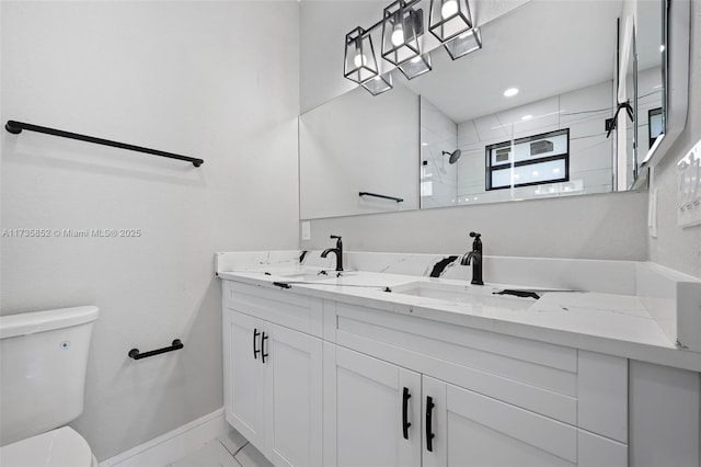 full bath featuring baseboards, toilet, tiled shower, and a sink