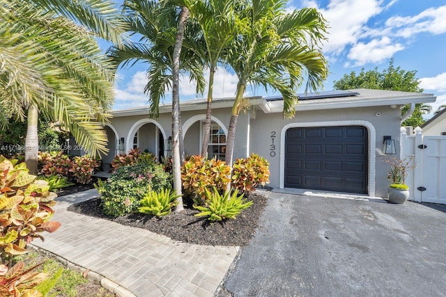 view of front of house with a garage and solar panels