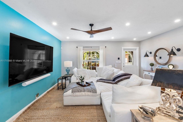 carpeted living room featuring a textured ceiling and ceiling fan