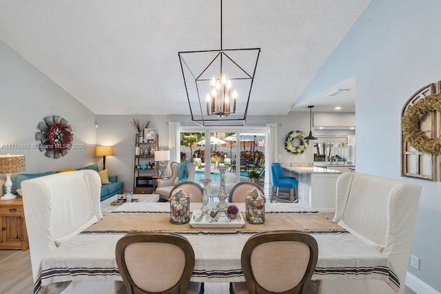 dining area with french doors, lofted ceiling, hardwood / wood-style floors, and a textured ceiling