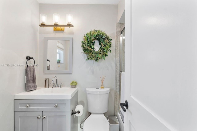 bathroom with vanity, toilet, and walk in shower