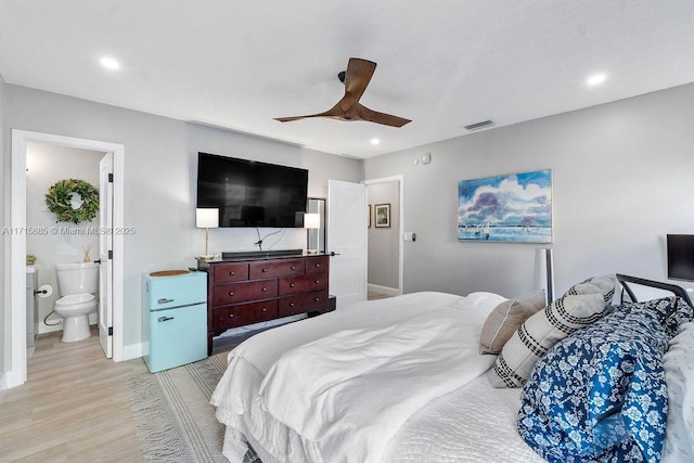 bedroom featuring fridge, ceiling fan, ensuite bathroom, and light hardwood / wood-style floors