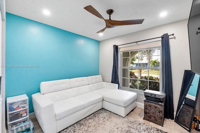 living room with ceiling fan and light wood-type flooring