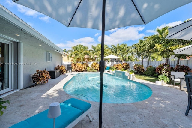 view of swimming pool with pool water feature and a patio area