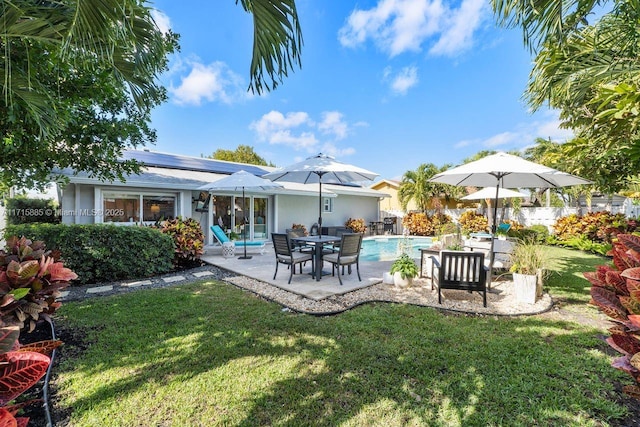 back of house featuring a lawn and a patio