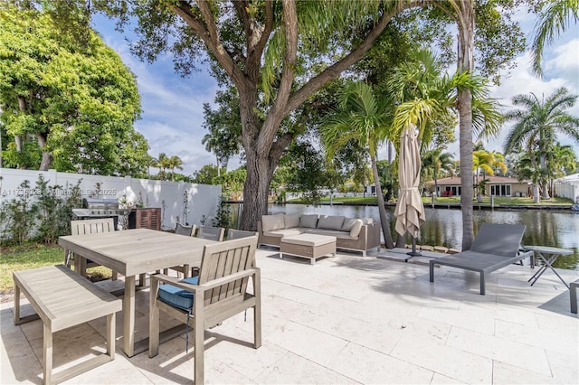 view of patio with a water view and outdoor lounge area