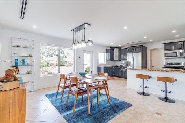 dining room featuring light tile patterned flooring and a healthy amount of sunlight