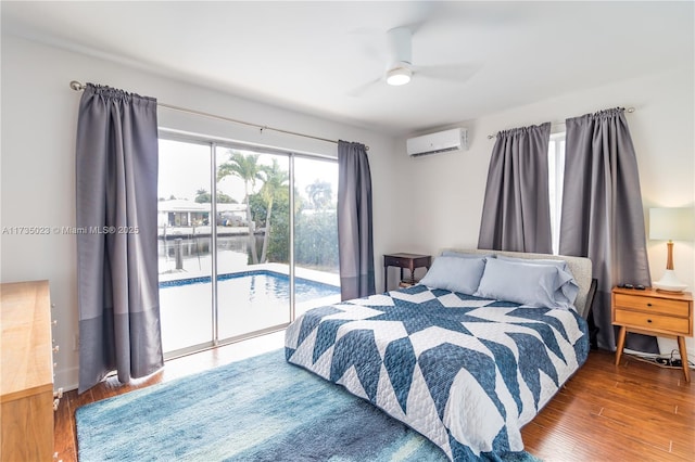 bedroom with ceiling fan, access to exterior, dark hardwood / wood-style flooring, and an AC wall unit