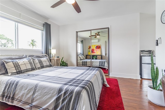 bedroom featuring a closet, dark hardwood / wood-style floors, and ceiling fan