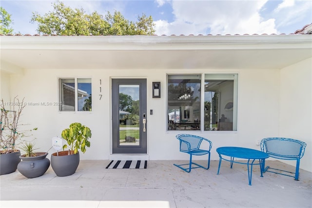 entrance to property with a patio