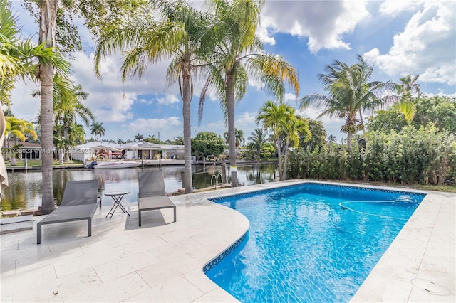 view of swimming pool featuring a patio and a water view