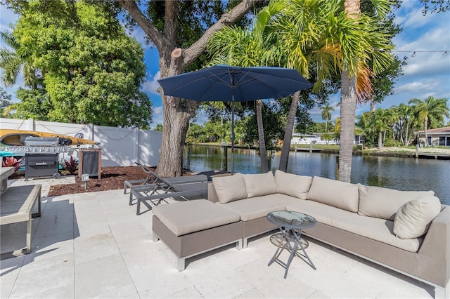 view of patio with a water view and an outdoor living space