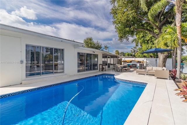 view of swimming pool featuring outdoor lounge area and a patio