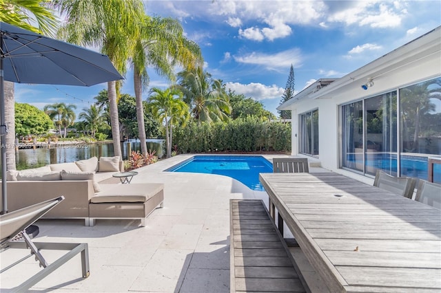 view of swimming pool with a water view and a patio