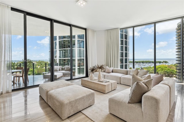 living room featuring a water view and floor to ceiling windows