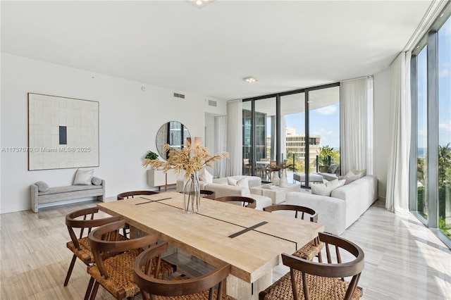 dining area featuring a wall of windows