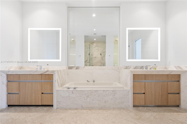 bathroom with independent shower and bath and vanity