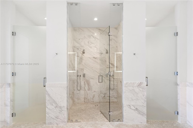 bathroom featuring a shower with door